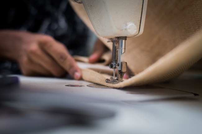 Close up of a bag being sewn together